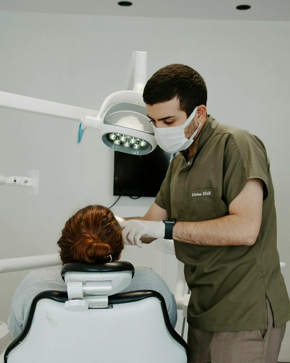 Odontóloga atendiendo a una paciente en un consultorio dental moderno con equipamiento de última generación
